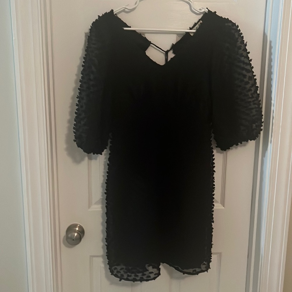 Textured black dress with puff sleeves and tie back/zipper. Size medium